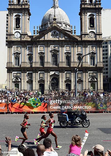 Bahrain's Eunice Jepkirui Kirwa, Ethiopia's Mare Dibaba and Kenya's Jemima Jelagat Sumgong lead the race in the Women's Marathon during the athletics...