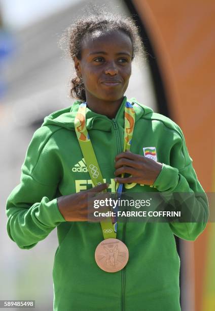 Bronze medalist Ethiopia's Mare Dibaba reacts during the podium ceremony for the Women's Marathon during the athletics event at the Rio 2016 Olympic...