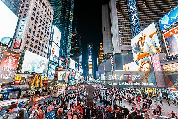 illuminated times square at night, new york city, ny, united states - broadway manhattan stock pictures, royalty-free photos & images