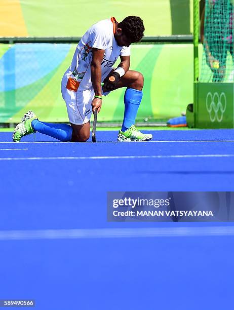 India's Uthappa Sannuvanda kneels on the pitch at the end of the men's quarterfinal field hockey Belgium vs India match of the Rio 2016 Olympics...