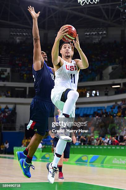 Klay Thompson of United States shoots past Boris Diaw of France during a Men's Preliminary Round Group A game between the United States and France on...