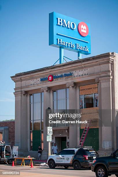 People survey damage to a few local business after rioters clashed with the Milwaukee Police Department protesting an officer involved killing August...