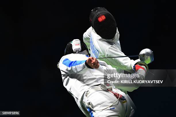 Ukraine's Dmytro Karyuchenko competes against Italy's Paolo Pizzo during the mens team epee semi-final bout between Italy and Ukraine as part of the...