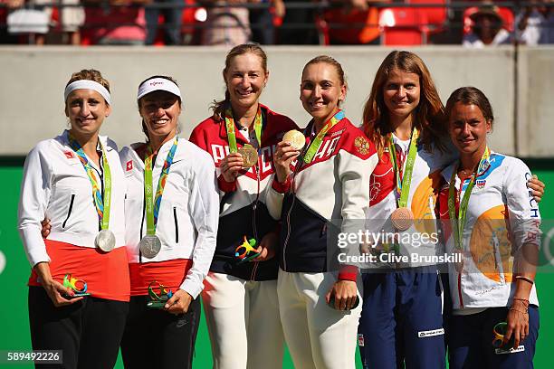 Silver medalists Timea Bacsinszky and Martina Hingis of Switzerland, gold medalists Ekaterina Makarova and Elena Vesnina of Russia and bronze...