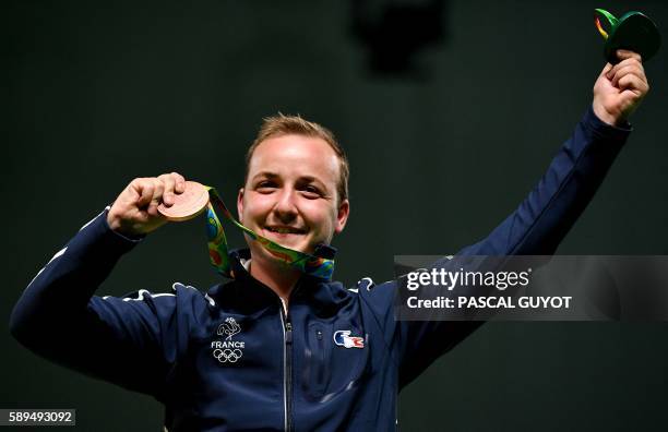 Bronze medallist France's Alexis Raynaud celebrates on the podium for the 50m Rifle 3 positions men's Finals shooting event at the Rio 2016 Olympic...