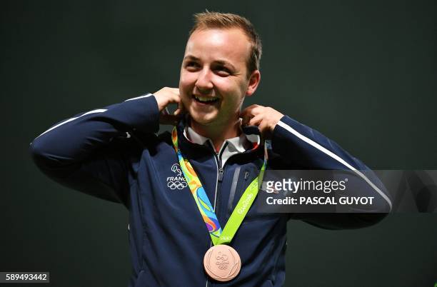 Bronze medallist France's Alexis Raynaud celebrates on the podium during the medal ceremony for the 50m Rifle 3 positions men's Finals shooting event...