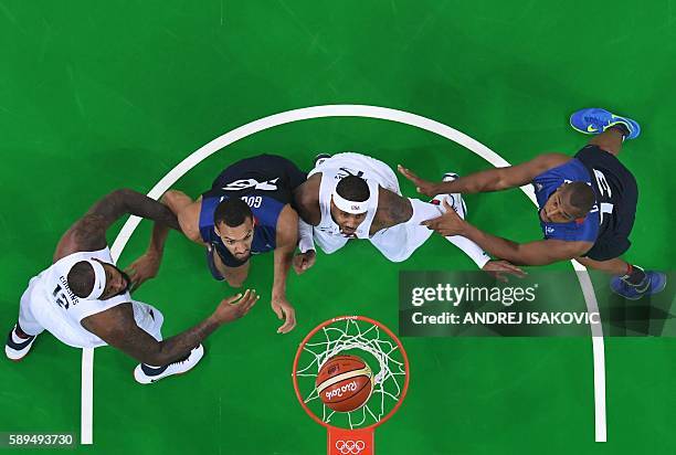 An overview shows USA's centre DeMarcus Cousins, France's centre Rudy Gobert, USA's forward Carmelo Anthony and France's power forward Boris Diaw eye...