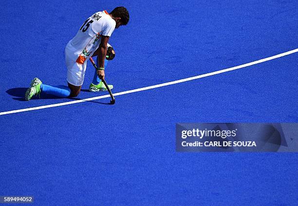 India's Uthappa Sannuvanda kneels on the pitch at the end of the men's quarterfinal field hockey Belgium vs India match of the Rio 2016 Olympics...