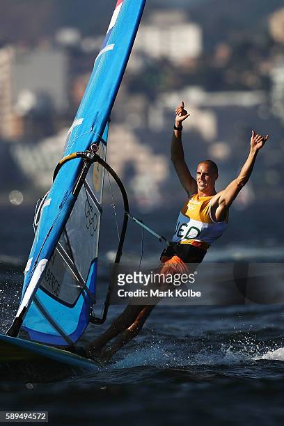 Dorian van Rijsselberghe of the Netherlands celebrates winning the overall Men's RS:X class on Day 9 of the Rio 2016 Olympic Games at the Marina da...