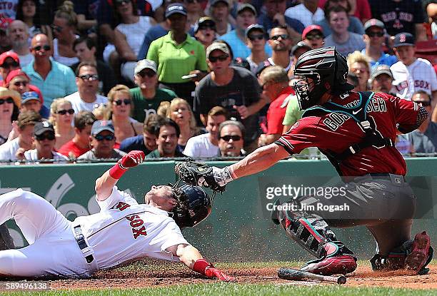 Tuffy Gosewisch of the Arizona Diamondbacks tags out Andrew Benintendi of the Boston Red Sox at the plate in the second inning at Fenway Park on...