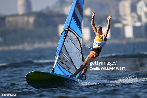 Netherlands' Dorian Van Rijsselberghe celebrates after winning the RS:X Men sailing final race on Guanabara Bay in Rio de Janerio during the Rio 2016...