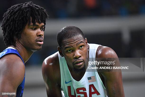 France's small forward Mickael Gelabale amd USA's guard Kevin Durant look on during a Men's round Group A basketball match between USA and France at...