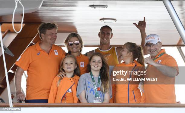 Netherlands' Dorian Van Rijsselberghe poses with Netherland's King Willem-Alexander, Queen Maxima and their daughters Catharina, Alexia, Ariane after...