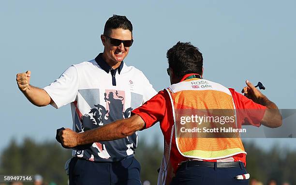 Justin Rose of Great Britain celebrates with caddie Mark Fulcher after winning in the final round of men's golf on Day 9 of the Rio 2016 Olympic...