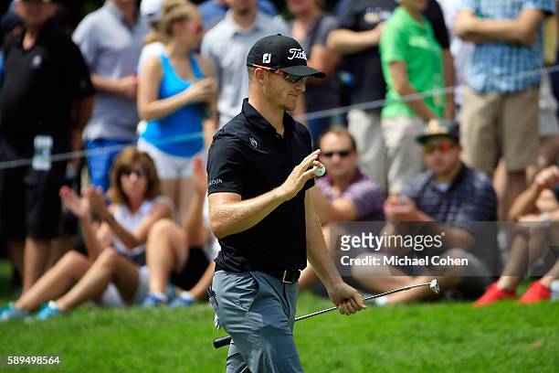 Morgan Hoffmann acknowledges the crowd on the fifth green during the final round of the John Deere Classic at TPC Deere Run on August 14, 2016 in...
