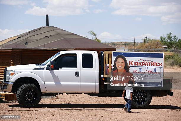 Child looks at campaign signage during an event for Representative Ann Kirkpatrick, a Democrat from Arizona, not pictured, on the Navajo Nation...