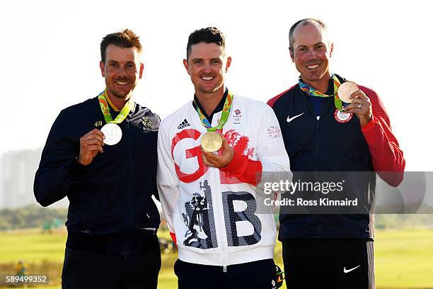 Justin Rose of Great Britain celebrates with the gold medal, Henrik Stenson of Sweden, silver medal, and Matt Kuchar of the United States, bronze...