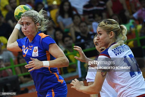 Netherlands' left back Estavana Polman shoots past Russia's left back Vladlena Bobrovnikova during the women's preliminaries Group B handball match...