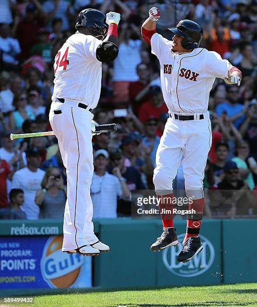 Mookie Betts of the Boston Red Sox celebrates his third home run of the game against the Arizona Diamondbacks with David Ortiz in the fifth inning at...