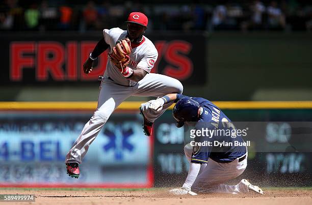 Orlando Arcia of the Milwaukee Brewers steals second base past Brandon Phillips of the Cincinnati Reds in the first inning at Miller Park on August...