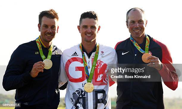 Justin Rose of Great Britain celebrates with the gold medal, Henrik Stenson of Sweden, silver medal, and Matt Kuchar of the United States, bronze...
