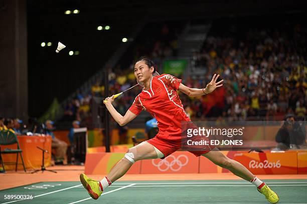 China's Wang Yihan returns to Germany's Karin Schnaase during their women's singles qualifying badminton match at the Riocentro stadium in Rio de...