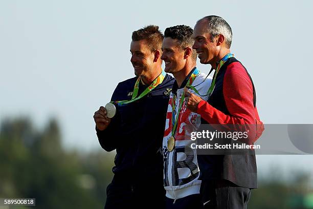 Justin Rose of Great Britain celebrates with the gold medal, Henrik Stenson of Sweden, silver medal, and Matt Kuchar of the United States, bronze...