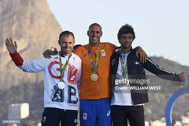 Netherlands' gold medallist Dorian Van Rijsselberghe , Britain's silver medallist Nick Dempsey and France's bronze medallist Pierre Le Coq pose on...