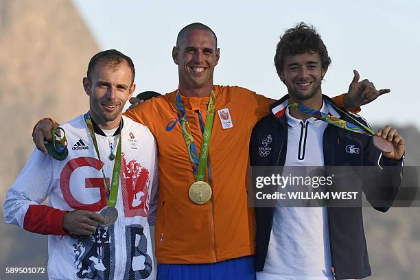 Netherlands' gold medallist Dorian Van Rijsselberghe , Britain's silver medallist Nick Dempsey and France's bronze medallist Pierre Le Coq pose on...