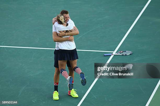 Jack Sock and Bethanie Mattek-Sands of the United States celebrate victory in the mixed doubles gold medal match against Rajeev Ram and Venus...