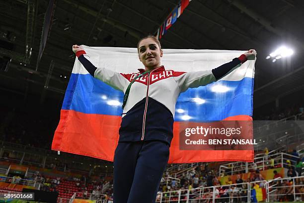 Russia's Aliya Mustafina celebrates after the women's uneven bars event final of the Artistic Gymnastics at the Olympic Arena during the Rio 2016...