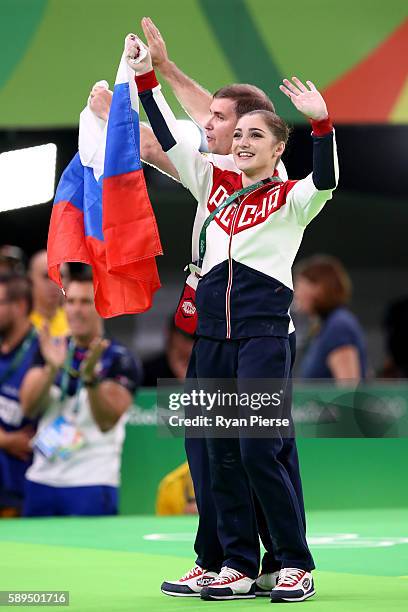 Aliya Mustafina of Russia celebrate winning the gold medal after the Women's Uneven Bars Final on Day 9 of the Rio 2016 Olympic Games at the Rio...