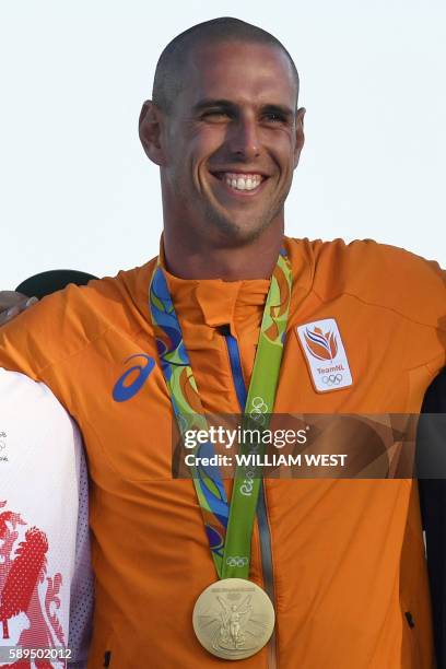 Netherlands' gold medallist Dorian Van Rijsselberghe celebrates on the podium after the RS:X Men sailing final race on Guanabara Bay in Rio de...