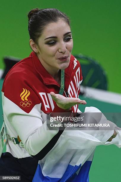 Russia's Aliya Mustafina celebrates after winning the women's uneven bars event final of the Artistic Gymnastics at the Olympic Arena during the Rio...