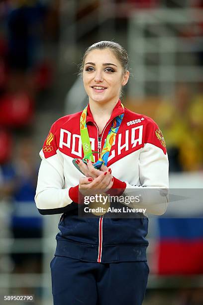 Gold medalist Aliya Mustafina of Russia celebrates on the podium at the medal ceremony for the Women's Uneven Bars on Day 9 of the Rio 2016 Olympic...