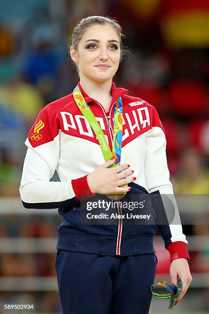 Gold medalist Aliya Mustafina of Russia celebrates on the podium at the medal ceremony for the Women's Uneven Bars on Day 9 of the Rio 2016 Olympic...