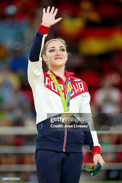 Gold medalist Aliya Mustafina of Russia celebrates on the podium at the medal ceremony for the Women's Uneven Bars on Day 9 of the Rio 2016 Olympic...