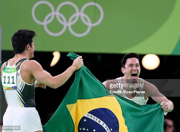 Diego Hypolito and Arthur Mariano of Brazil celebrate winning silver and bronze respectively after the Men's Floor Exercise Final on Day 9 of the...