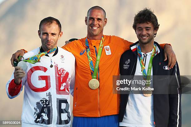 Silver medalist Nick Dempsey of Great Britain, gold medalist Dorian van Rijsselberghe of the Netherlands and bronze medalist Pierre le Coq of France...