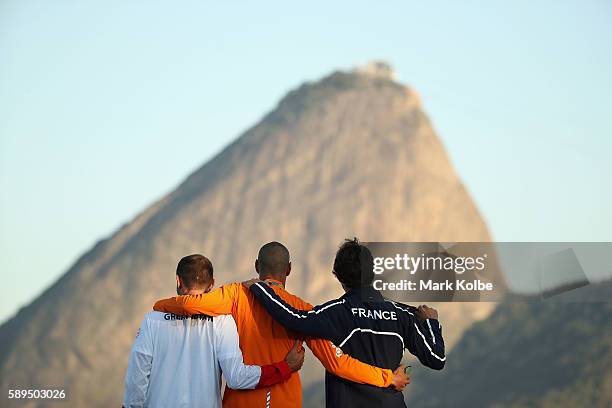 Silver medalist Nick Dempsey of Great Britain, gold medalist Dorian van Rijsselberghe of the Netherlands and bronze medalist Pierre le Coq of France...