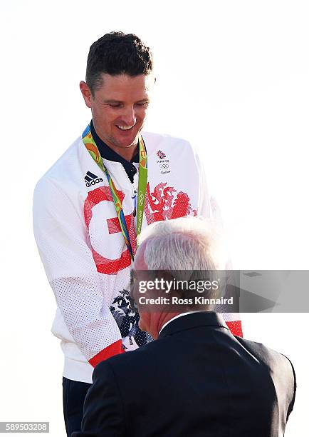 Wada president Craig Reedie presets the gold medal to Justin Rose of Great Britain after the final round of men's golf on Day 9 of the Rio 2016...