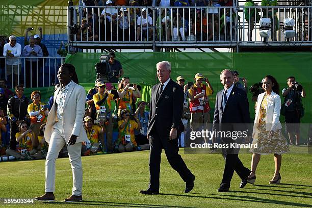 President Peter Dawson and Wada president Craig Reedie take part in th medal presentation following the final round of men's golf on Day 9 of the Rio...