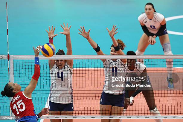 Alessia Orro and Cristina Chirichella of Italy block the ball against Daly Santana of Puerto Rico during the women's qualifying volleyball match...