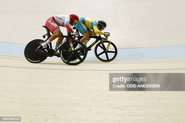 Russia's Denis Dmitriev competes against Australia's Matthew Glaetzer during the Men's Sprint final track cycling event at the Velodrome during the...