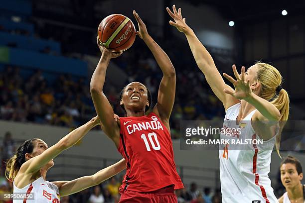 Canada's shooting guard Nirra Fields goes to the basket between Spain's guard Anna Cruz and Spain's power forward Laura Gil during a Women's round...