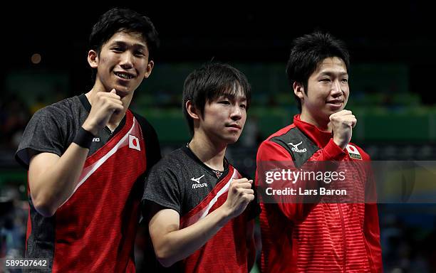 Maharu Yoshimura, Koki Niwa and Jun Mizutani pose for a picture after winning the Table Tennis Men's Quarterfinal Match between Japan and Hong Kong...