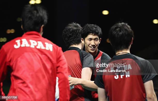 Maharu Yoshimura of Japan celebrates with team mates after winning the Table Tennis Men's Quarterfinal Match between Japan and Hong Kong on August...