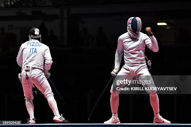 Italy's Paolo Pizzo and France's Yannick Borel react during the mens team epee gold medal bout between Italy and France as part of the fencing event...