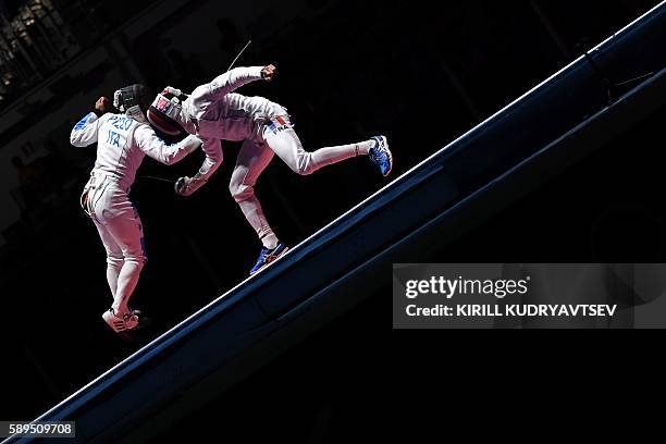 Italy's Paolo Pizzo competes against France's Yannick Borel during the mens team epee gold medal bout between Italy and France as part of the fencing...