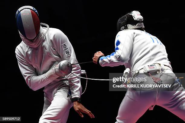 Italy's Paolo Pizzo competes against France's Yannick Borel during the mens team epee gold medal bout between Italy and France as part of the fencing...